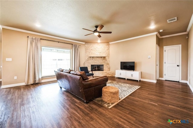 living room with baseboards, dark wood-type flooring, a stone fireplace, and ornamental molding