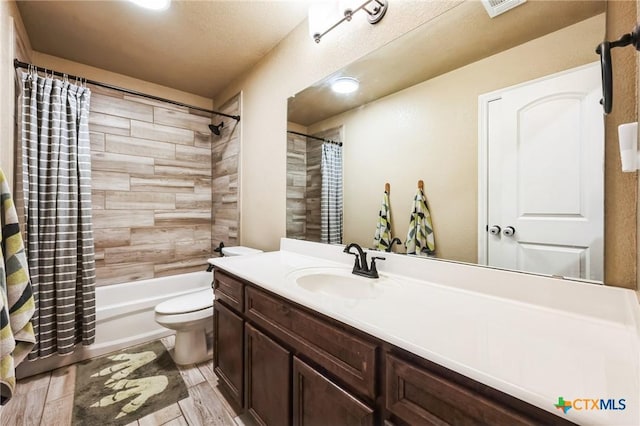 full bath featuring shower / bath combo with shower curtain, toilet, and vanity