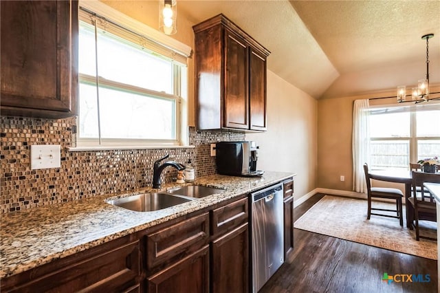 kitchen featuring dark wood finished floors, lofted ceiling, a sink, dark brown cabinetry, and dishwasher