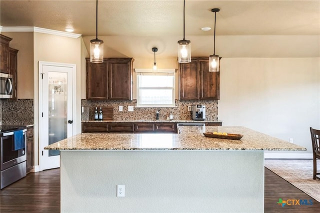 kitchen featuring dark wood-style floors, light stone countertops, a kitchen island, stainless steel appliances, and dark brown cabinets