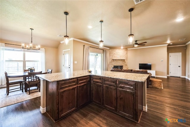 kitchen with dark brown cabinetry, dark wood finished floors, a fireplace, and a textured ceiling