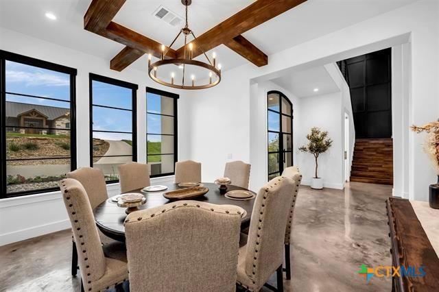 117 Legendary Estates Dr, Burnet, TX 78611 - dining room with finished concrete floors, a chandelier, baseboards, beam ceiling, and recessed lighting
