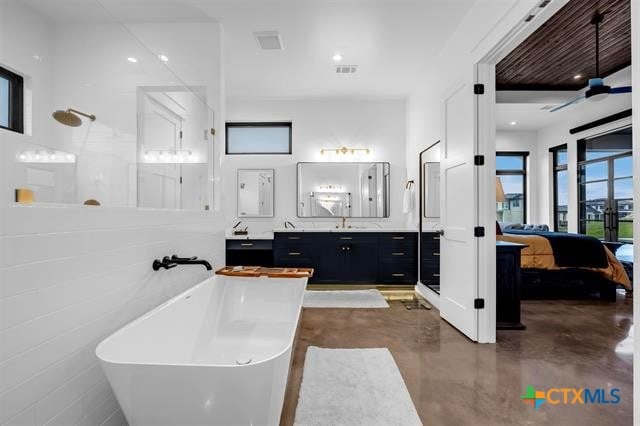 bathroom featuring concrete flooring, vanity, ceiling fan, and separate shower and tub