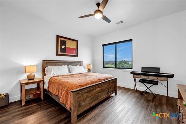 bedroom with ceiling fan and dark hardwood / wood-style floors