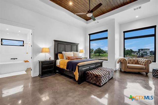 117 Legendary Estates Dr, Burnet, TX 78611 - bedroom featuring concrete floors, a tray ceiling, wooden ceiling, baseboards, and recessed lighting
