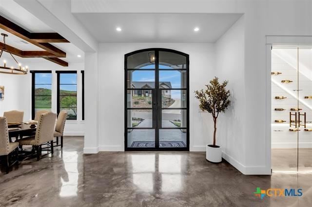 117 Legendary Estates Dr, Burnet, TX 78611 - entryway featuring finished concrete flooring, baseboards, a chandelier, and recessed lighting