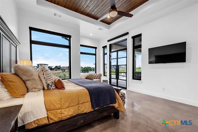 bedroom featuring access to exterior, ceiling fan, a raised ceiling, and wooden ceiling