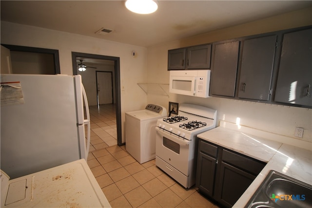 kitchen featuring dark brown cabinetry, ceiling fan, light tile patterned floors, washer / clothes dryer, and white appliances