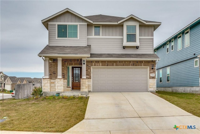 craftsman-style house featuring a front yard, covered porch, and a garage