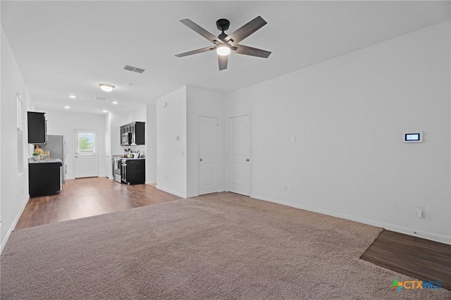 5806 Gulf Mdw, Converse, TX 78109 - unfurnished living room with light carpet, a ceiling fan, recessed lighting, and light wood-style floors