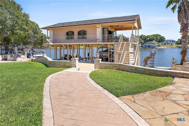 exterior space with a water view and a yard