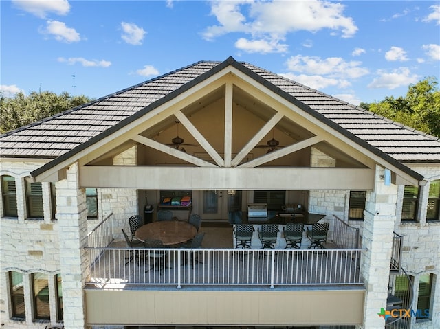 rear view of property featuring ceiling fan and an outdoor hangout area