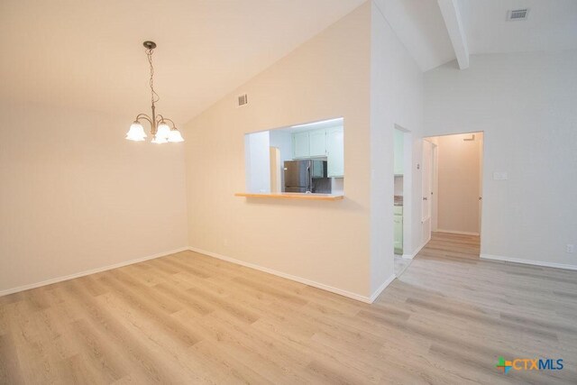 spare room with high vaulted ceiling, a chandelier, baseboards, light wood-type flooring, and visible vents