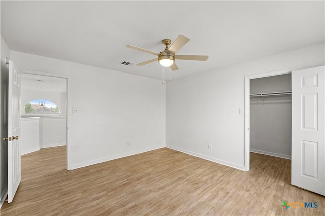 unfurnished bedroom with baseboards, visible vents, light wood finished floors, and a closet