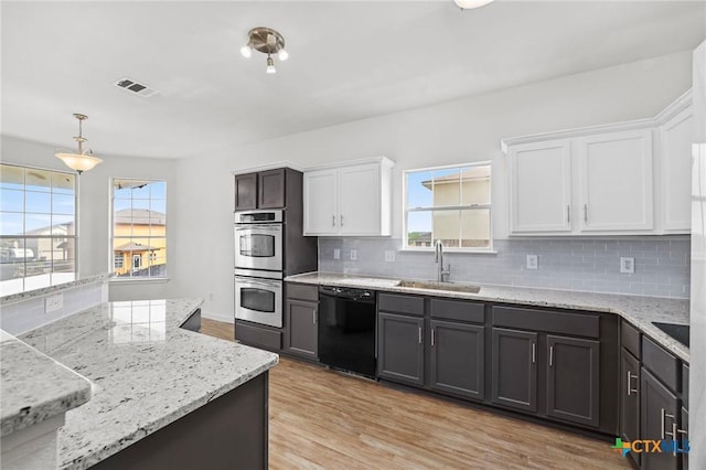 kitchen featuring tasteful backsplash, a sink, stainless steel double oven, dishwasher, and white cabinetry