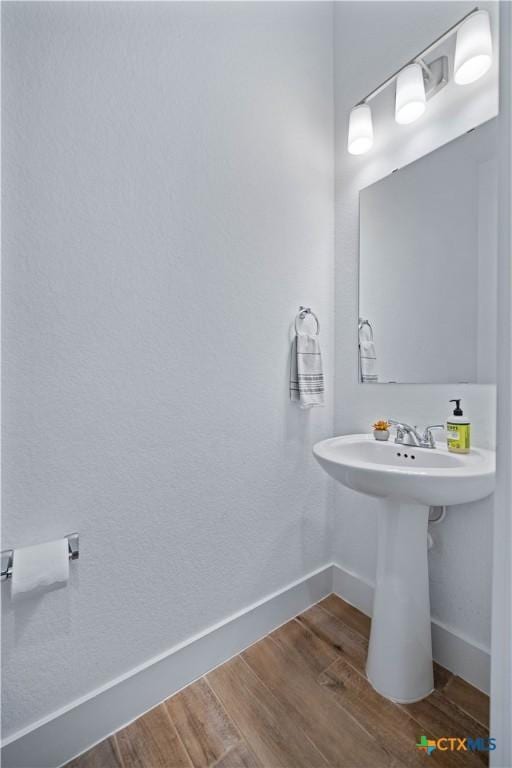 385 Althea, New Braunfels, TX 78132 - bathroom featuring baseboards and wood finished floors