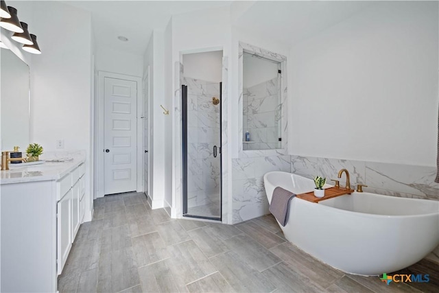 385 Althea, New Braunfels, TX 78132 - bathroom with vanity, a marble finish shower, a freestanding bath, and tile walls
