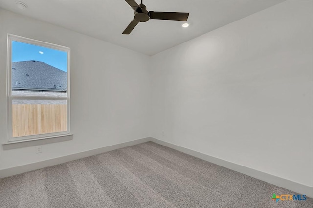 carpeted empty room featuring ceiling fan