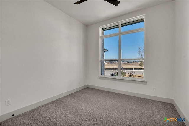 empty room with ceiling fan and carpet