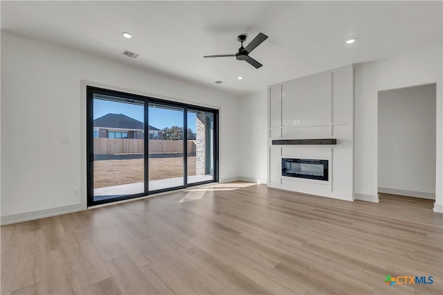 unfurnished living room with light hardwood / wood-style floors and ceiling fan