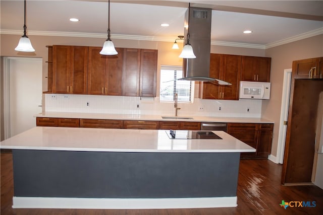 kitchen with light countertops, white microwave, a sink, and brown cabinets