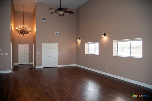 unfurnished room featuring baseboards, visible vents, dark wood-style flooring, and ceiling fan with notable chandelier