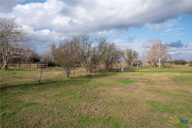 view of yard featuring a rural view and fence