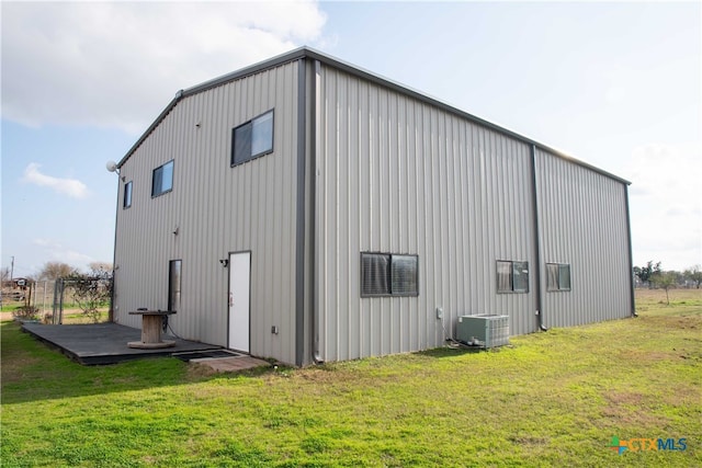 exterior space featuring a lawn and central air condition unit