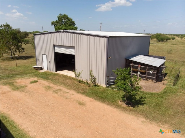 view of pole building with dirt driveway