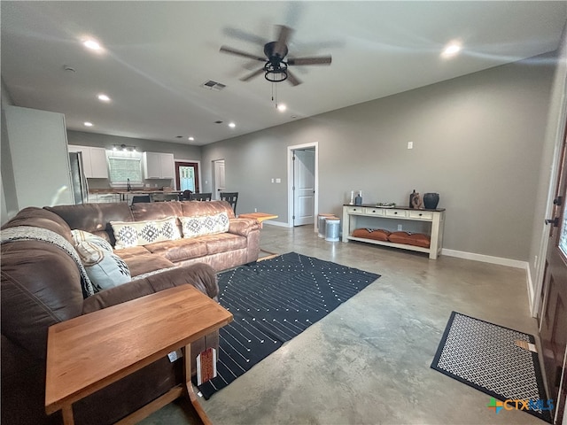 living room featuring sink and ceiling fan