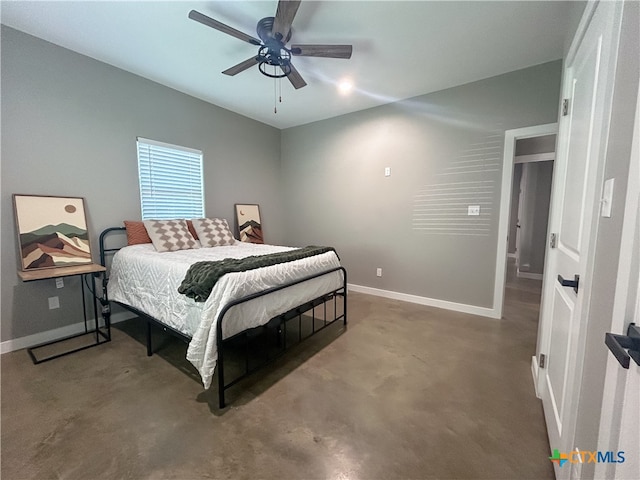 bedroom with ceiling fan and concrete floors