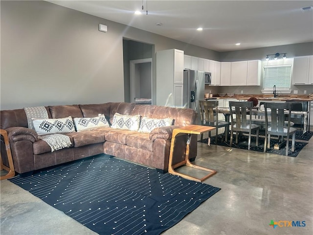3306 Cypress, Victoria, TX 77901 - living area featuring finished concrete flooring and recessed lighting