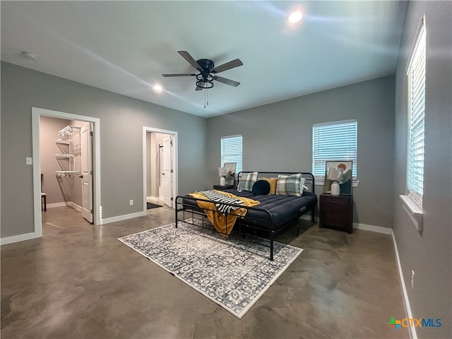 bedroom featuring a spacious closet, ceiling fan, and ensuite bathroom