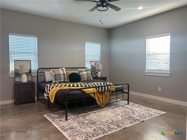 bedroom featuring multiple windows and ceiling fan