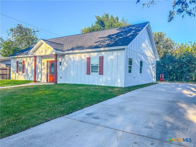 3306 Cypress, Victoria, TX 77901 - view of front of house featuring a front lawn, board and batten siding, roof with shingles, and driveway