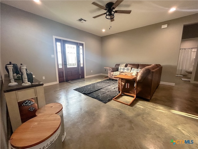 living room featuring concrete flooring and ceiling fan