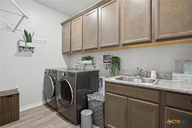 5106 La Piedra Ln, Killeen, TX 76549 - laundry area with independent washer and dryer, cabinet space, and light wood finished floors