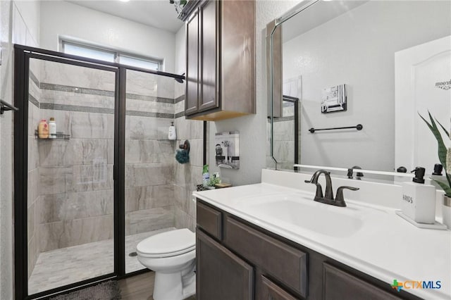 5106 La Piedra Ln, Killeen, TX 76549 - bathroom featuring a stall shower, vanity, and wood finished floors