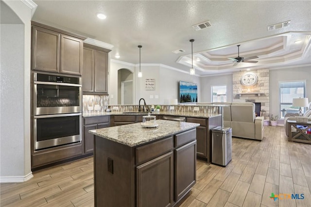 5106 La Piedra Ln, Killeen, TX 76549 - kitchen featuring stainless steel appliances, ceiling fan, light wood-style flooring, a peninsula, and plenty of natural light