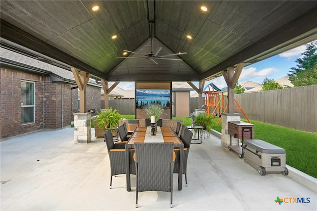 5106 La Piedra Ln, Killeen, TX 76549 - fenced backyard with ceiling fan, a playground, a patio area, and outdoor dining area