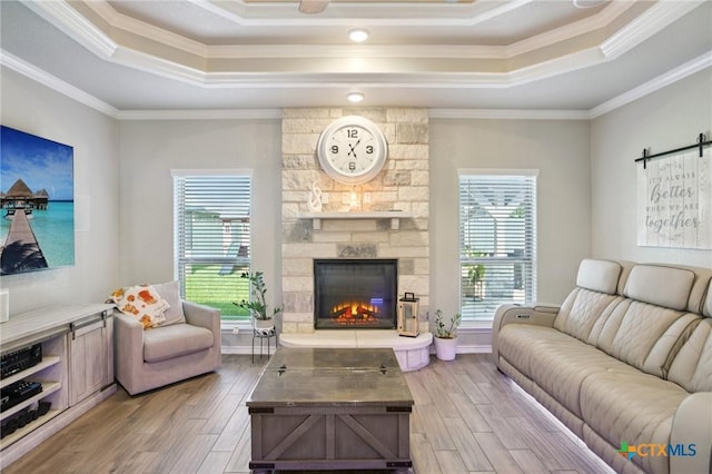 5106 La Piedra Ln, Killeen, TX 76549 - living area with a raised ceiling, crown molding, wood finished floors, and a stone fireplace
