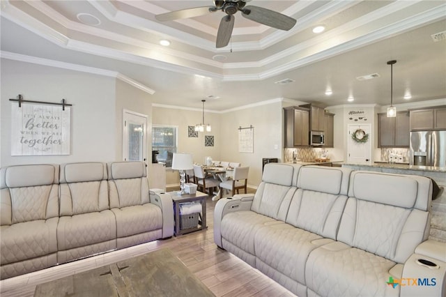 5106 La Piedra Ln, Killeen, TX 76549 - living room featuring a tray ceiling, ceiling fan, crown molding, recessed lighting, and light wood-type flooring
