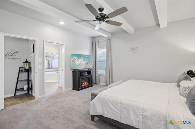 5106 La Piedra Ln, Killeen, TX 76549 - carpeted bedroom with beamed ceiling, a glass covered fireplace, connected bathroom, a ceiling fan, and recessed lighting