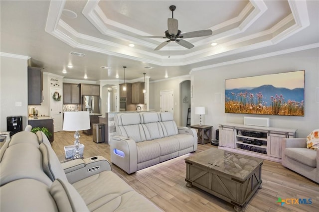 5106 La Piedra Ln, Killeen, TX 76549 - living area featuring a tray ceiling, ornamental molding, a ceiling fan, light wood finished floors, and recessed lighting