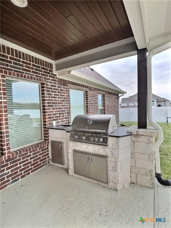 view of patio / terrace with an outdoor kitchen, sink, and grilling area