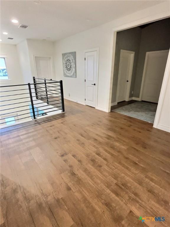 empty room with hardwood / wood-style flooring