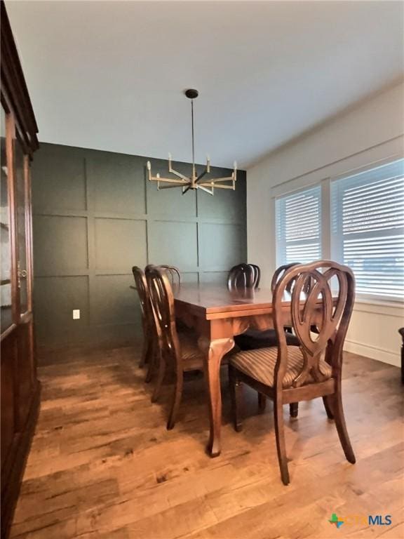 dining room featuring hardwood / wood-style floors and a notable chandelier