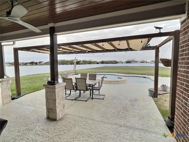 view of patio / terrace with ceiling fan and a water view