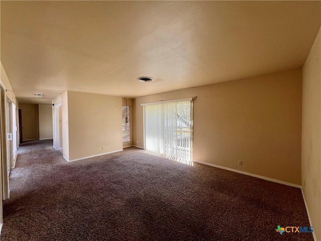 carpeted spare room with visible vents and baseboards