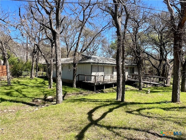 view of yard featuring a deck and fence